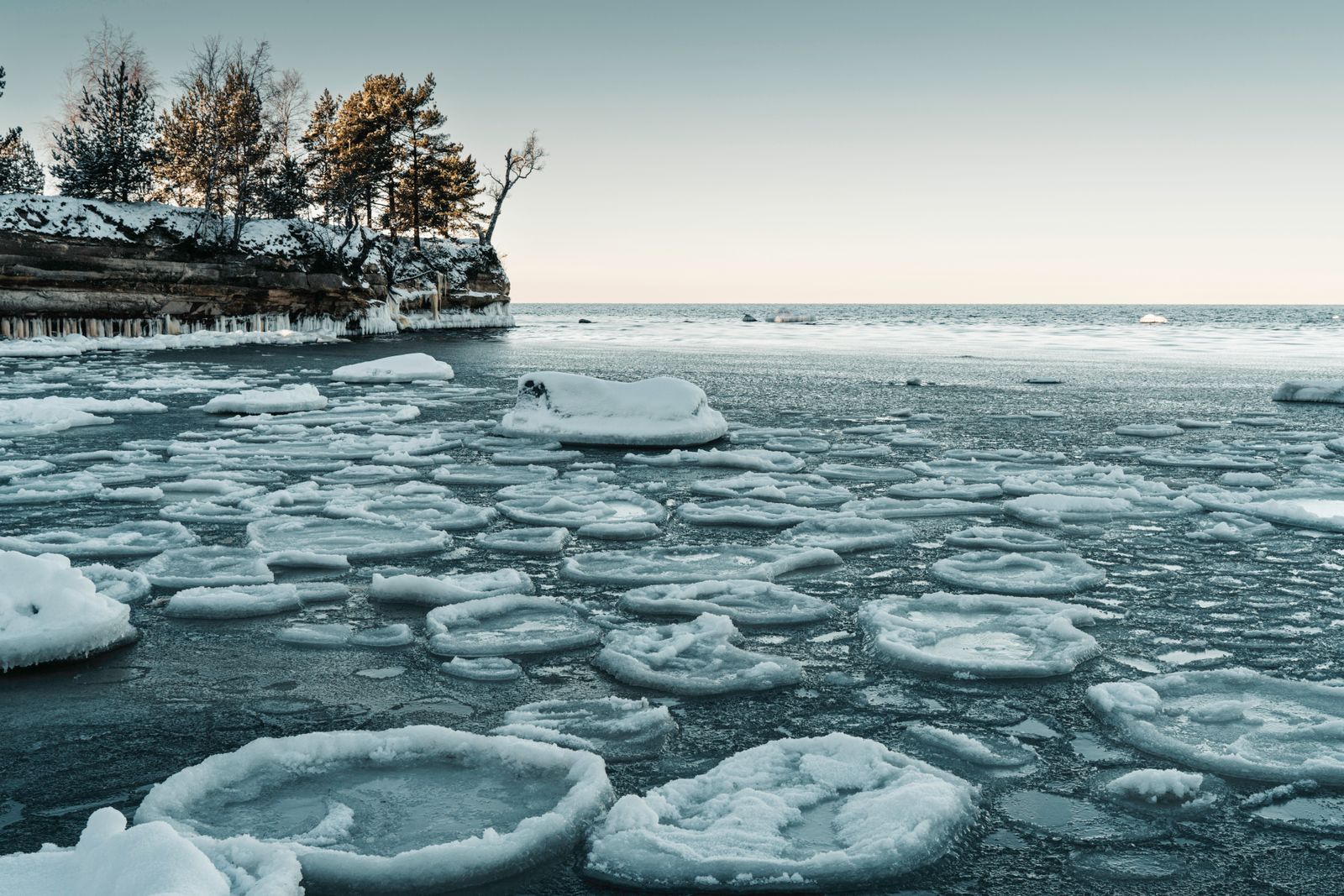A frozen Wisconsin lake in winter with snow along the shoreline